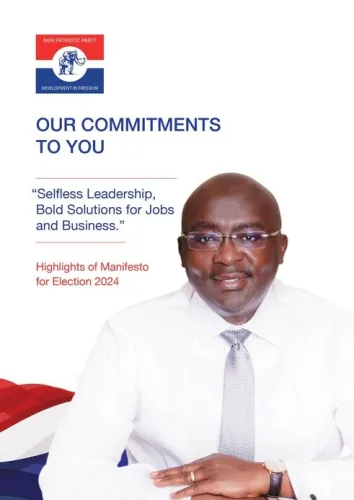 NPP presidential candidate Dr. Mahamudu Bawumia delivering a speech during the manifesto launch event. He stands at a podium, addressing an attentive audience, with party banners and branding in the background. Dr. Bawumia is seen confidently presenting key points, emphasizing his vision and goals for the future of Ghana. The atmosphere is formal, highlighting the importance of the occasion, as party members and supporters gather to witness the unveiling of the manifesto.