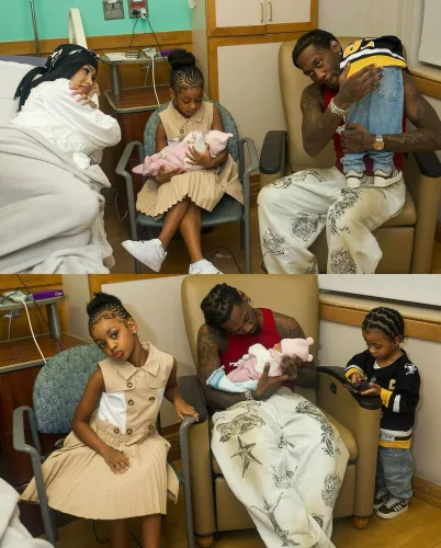 Cardi B posing with all three of her children, including her newborn, smiling as she embraces them in a heartwarming family moment.