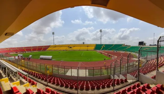 Angled view of Baba Yara Sports Stadium in Kumasi, Ghana, showcasing the football pitch, stands, and overall layout from the side.