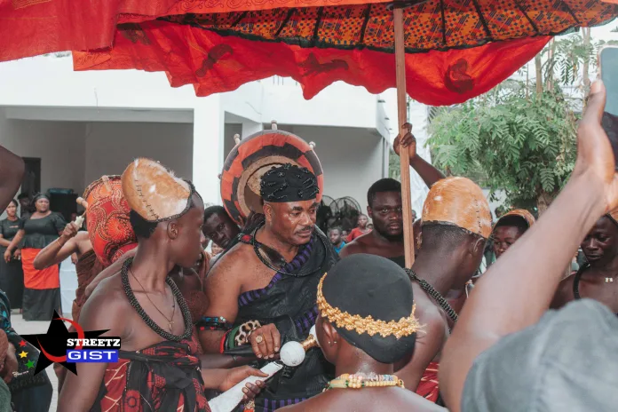 A traditional leader captured in a shot, seated and surrounded by his delegation at Na God's Fc's Dad funeral