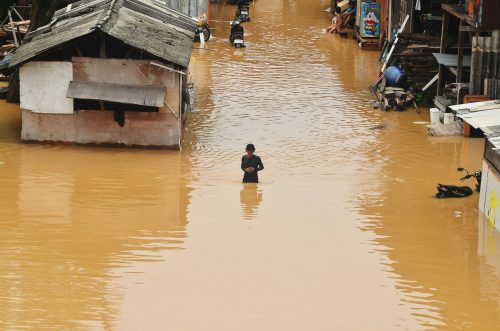 Flooded African village showing the impact of climate change on vulnerable communities